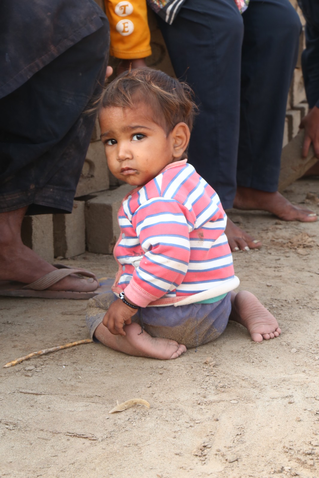 A young child from a family at the kiln